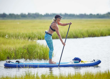 woman paddling on Long Board 11 in waterway