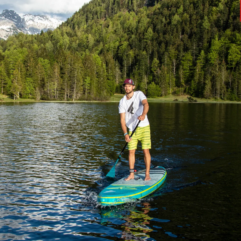 Fanatic Fly Air Premium with man on lake with mountains 