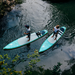 areal view or two riders on Ray Air Premium paddle boards on lake. 