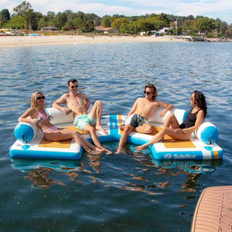 two couples relaxing on Solstice C Dock with removable pillows on lake