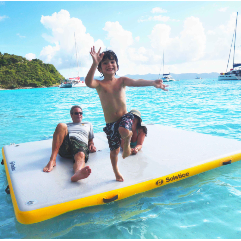 Family of 3 relaxing on Solstice Water Sports 10'x8' Inflatable Dock