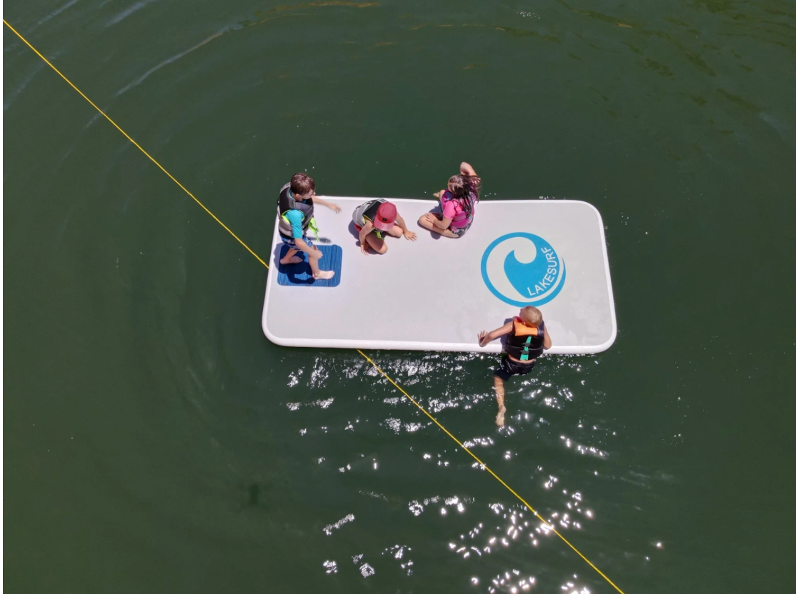 Lakesurf Slide Island inflatable dock/slide combo in flat configuration on lake