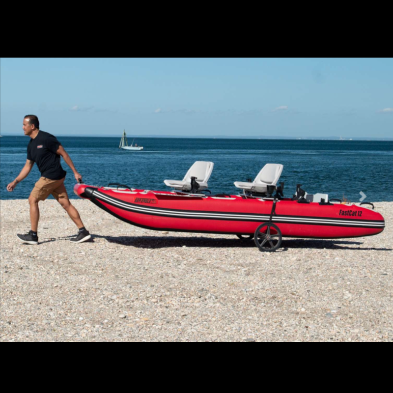 Man pulling FastCat 12' Inflatable Catamaran Boat on seashore