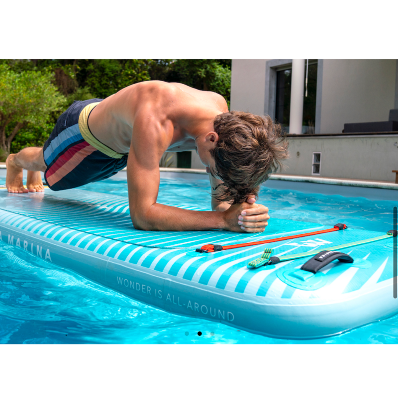 Guy doing plank exercise in swimming pool, on the PEACE inflatable platform by Aqua Marina